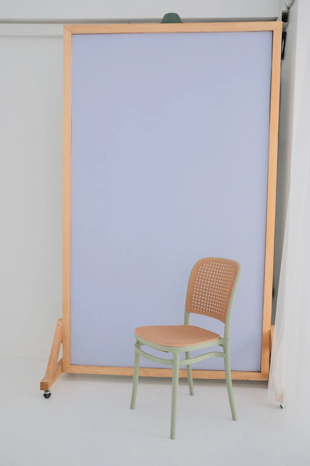 Cane chair in front of the lilac backdrop