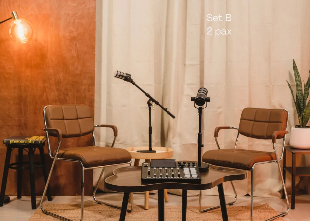 Set B: two chairs and microphones in front of the copper wall