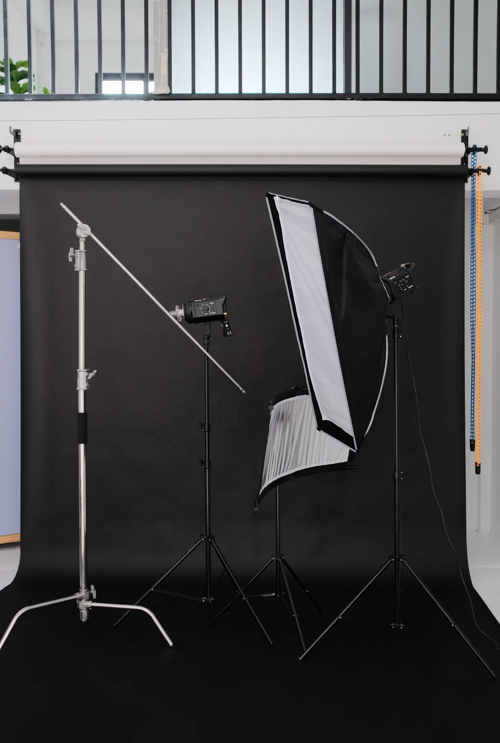 Softbox lights on stands in front of a black paper backdrop